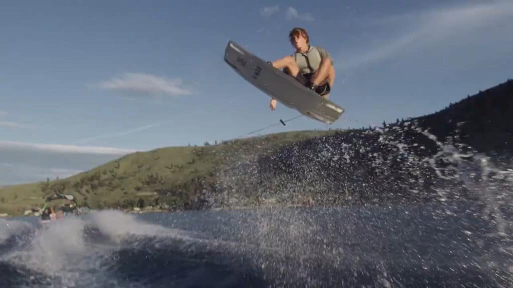 Wakeboarder catching air on the water